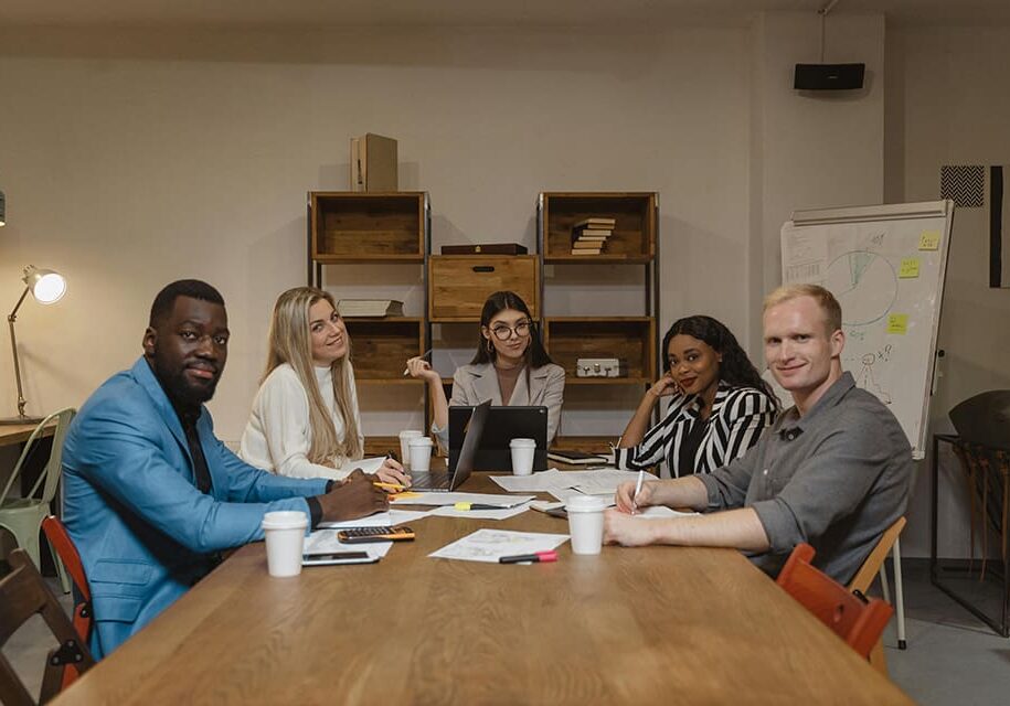 Diverse team meeting around table.