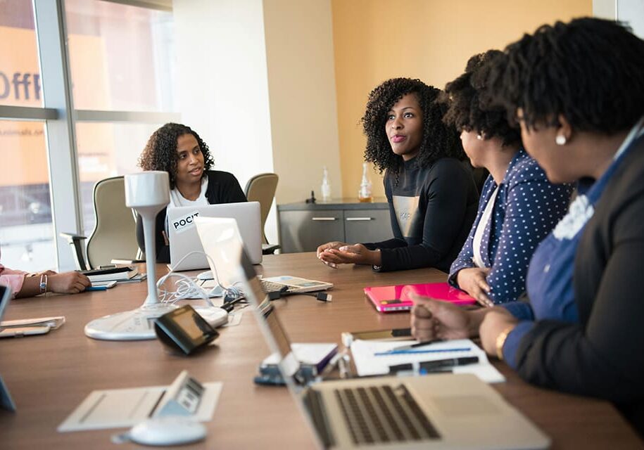 Four women meeting around a table.